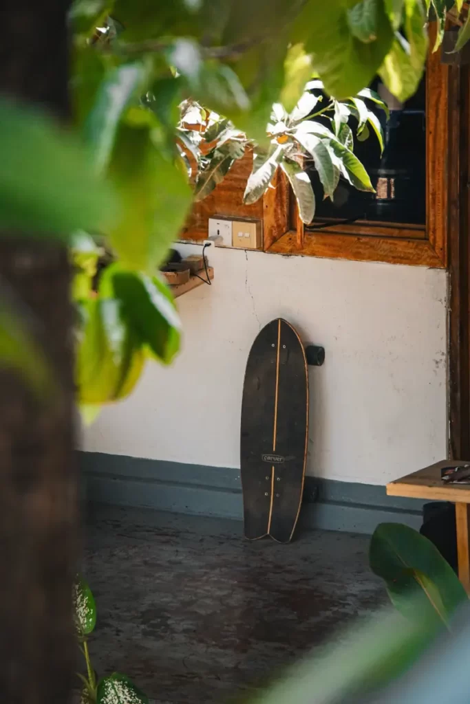 A skateboard against a way in a hostel