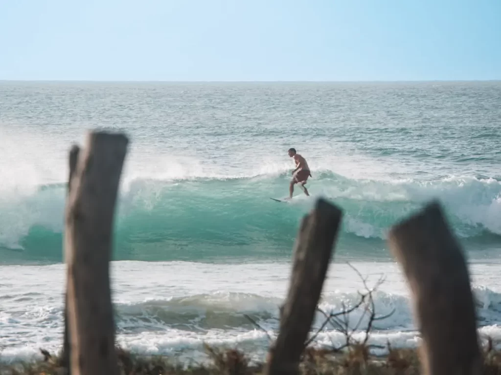 A man riding a close out and Lighthouse Point Break
