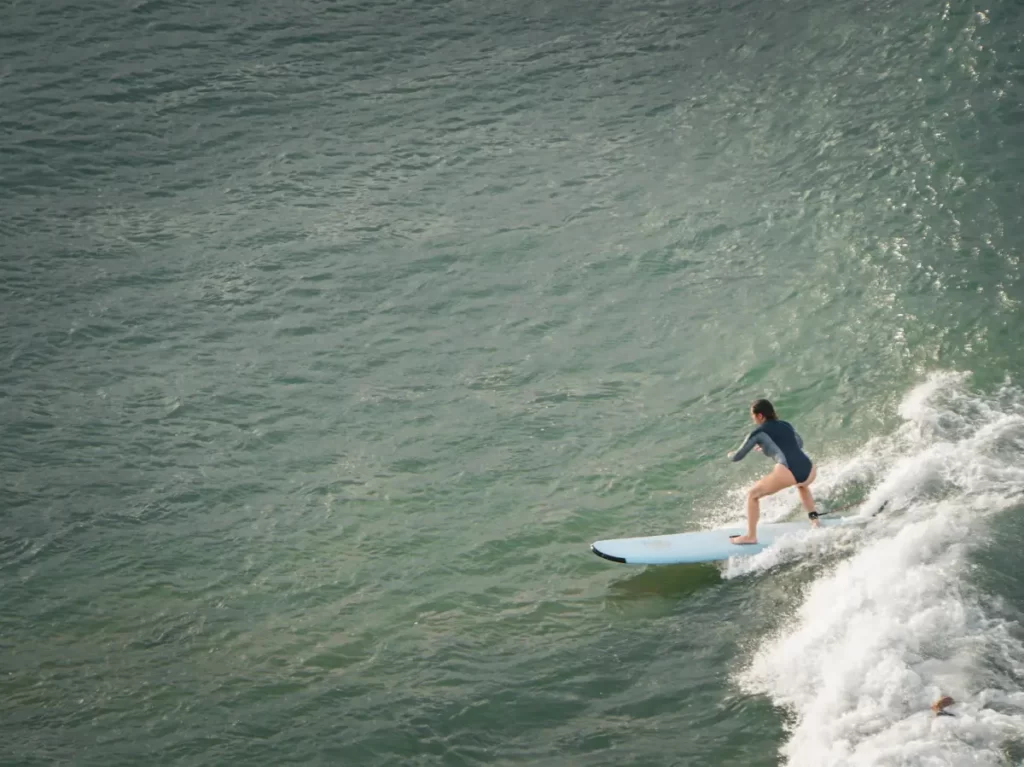 A beginner surfer on a wave taken from the top of Elephant Rock