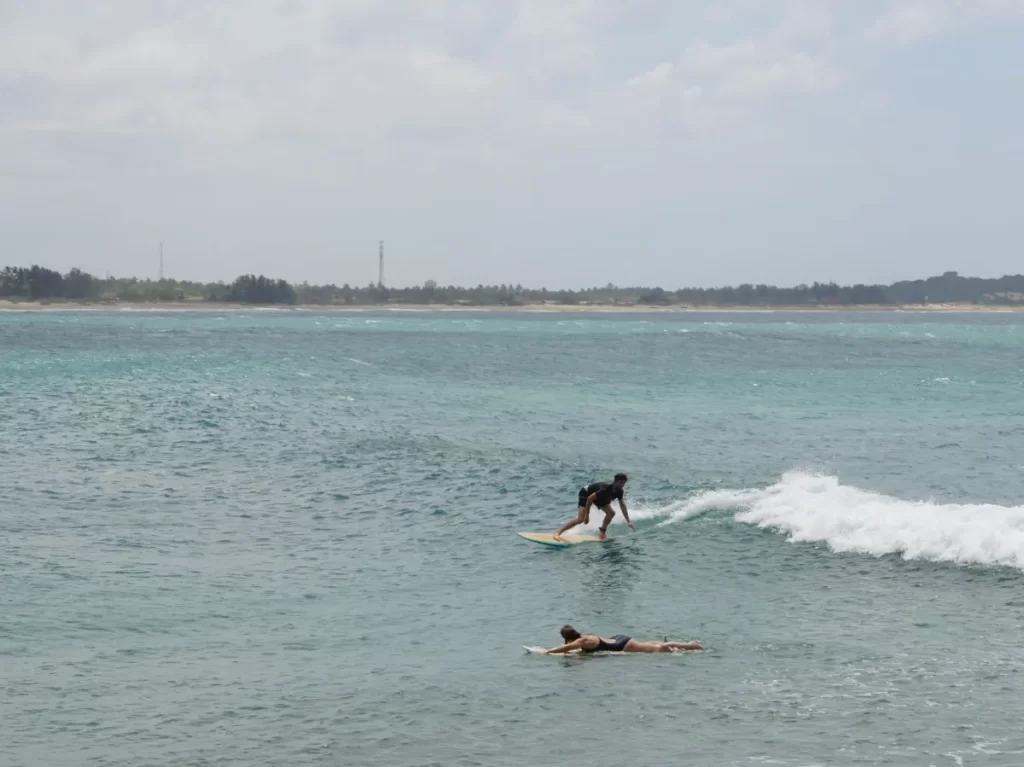 A beginner surfer on a small wave at Elephant Rock near Arugam Bay