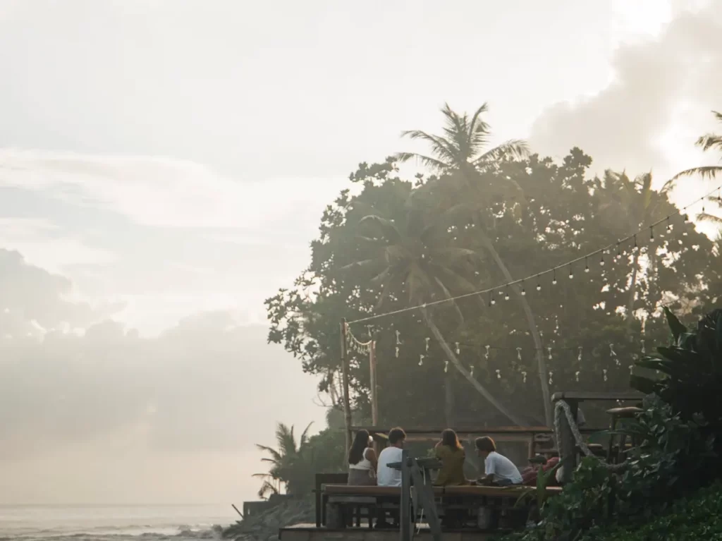 A group of people have drinks on the Crust balcony in Ahangama