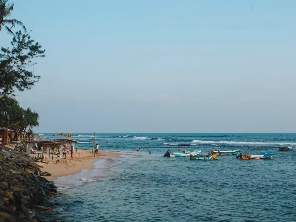 A number of beach shacks and boats near Kabalana beach in Ahangama