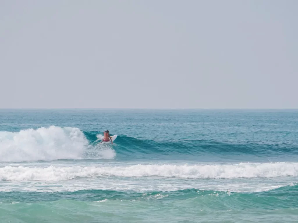 A surfer making a right hand turn at sticks surf spot in Ahangama