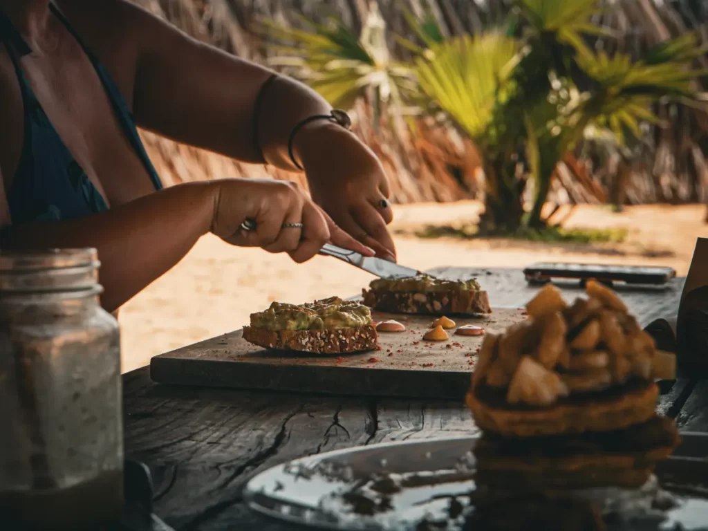A girl eating avocado on toast at Hilltop Cabanas restaurant on Lighthouse Beach