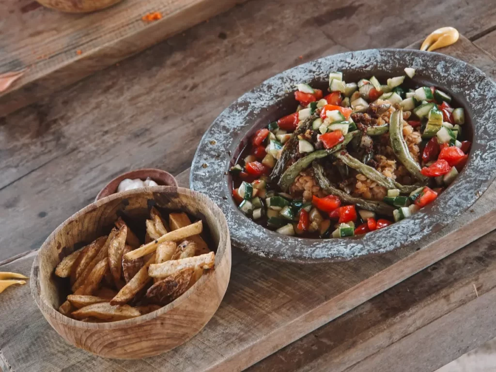 A greek salad and dahl meal with fries served at Hilltop Cabanas restaurant