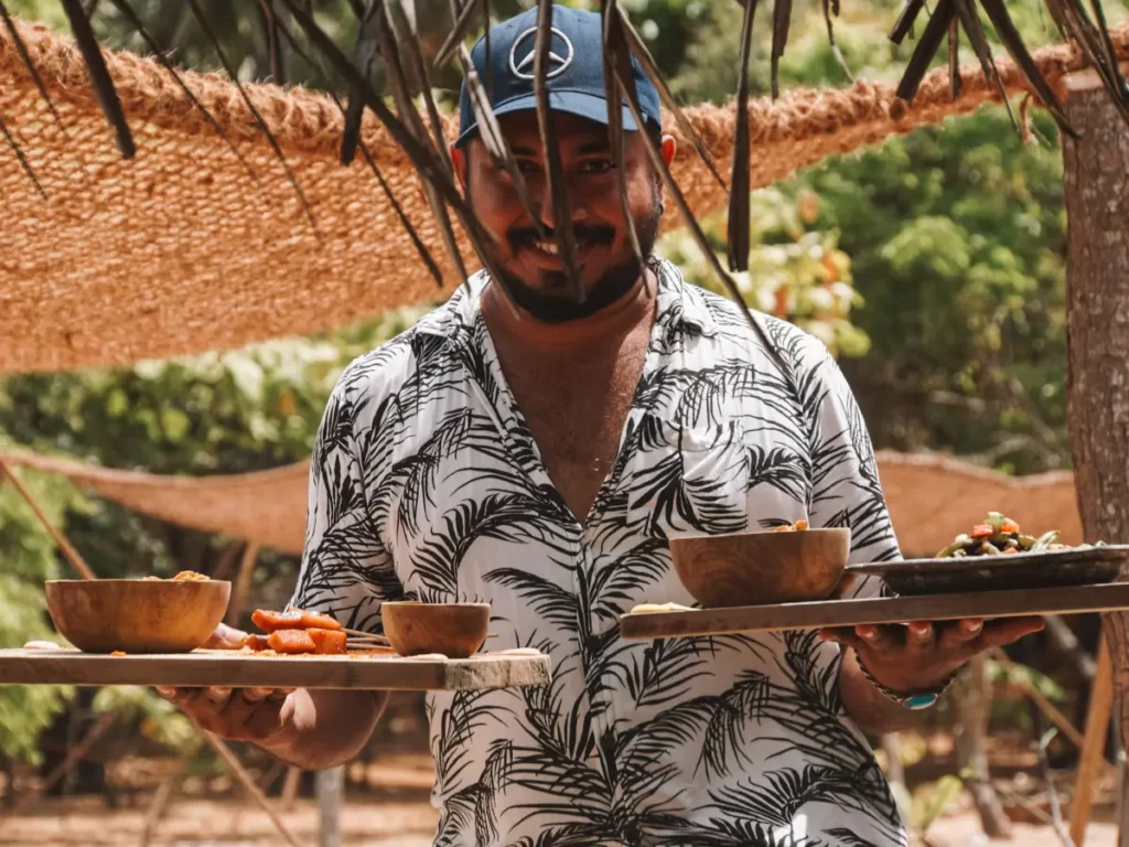 A local Sri Lankan man serving two meals at Hilltop Cabanas restaurant