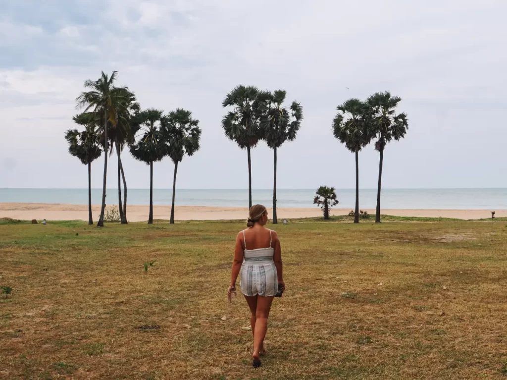 A girl walking towards the beach and ocean from her cabana at Jetwing Surf