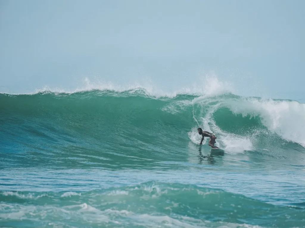 A local surfer carvers on a big wave at the Madiha Right surf point