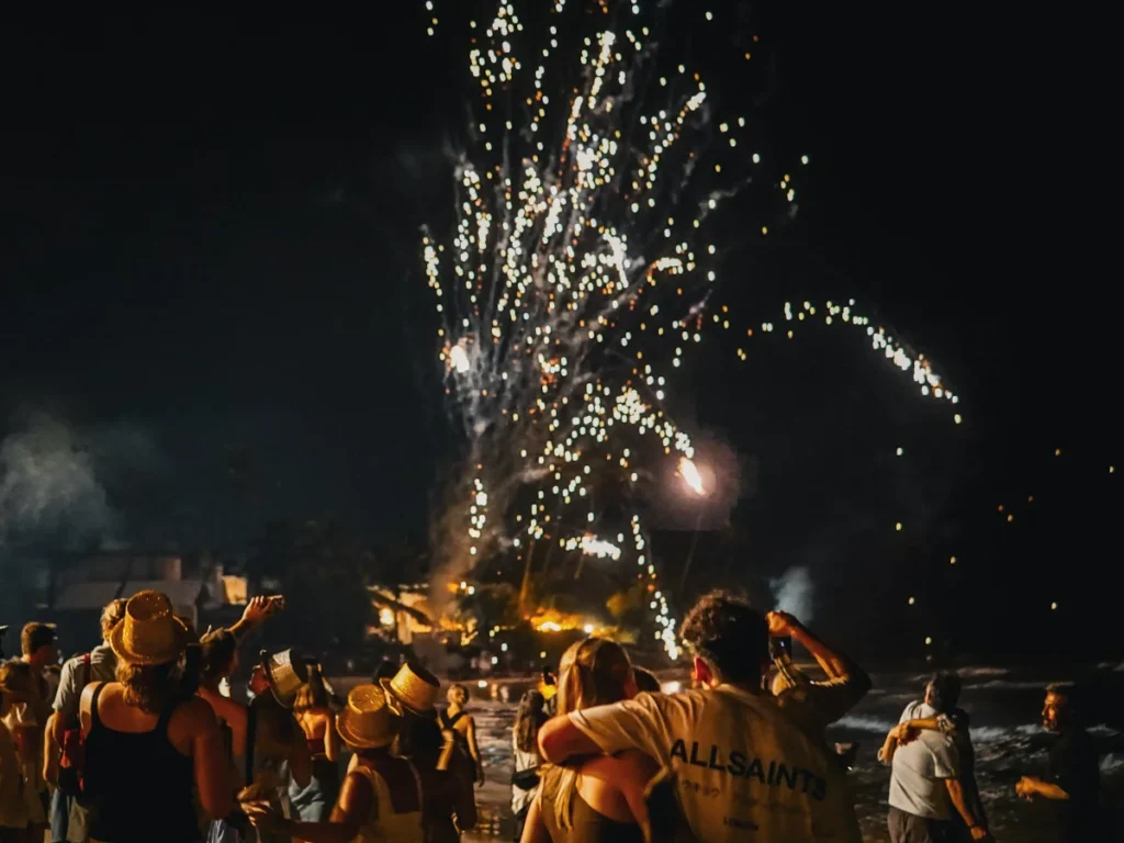 A couple watches fireworks at a beach party in Ahangama