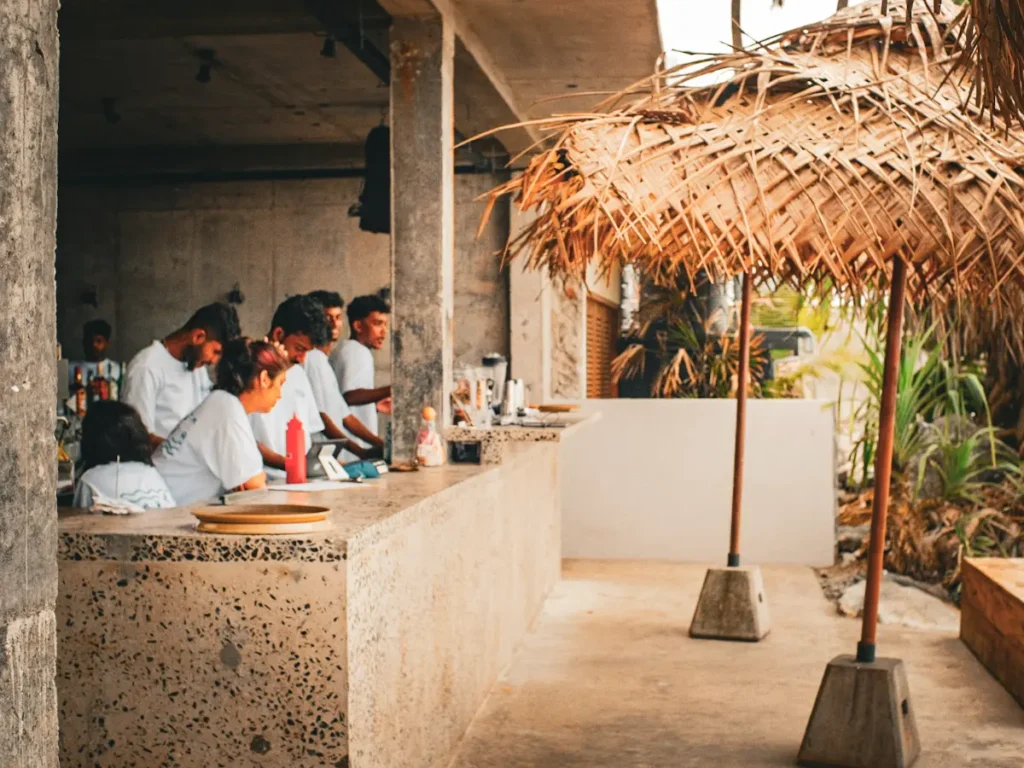 People sit inside at Ceylon Sliders Ahangama to get out of the sun