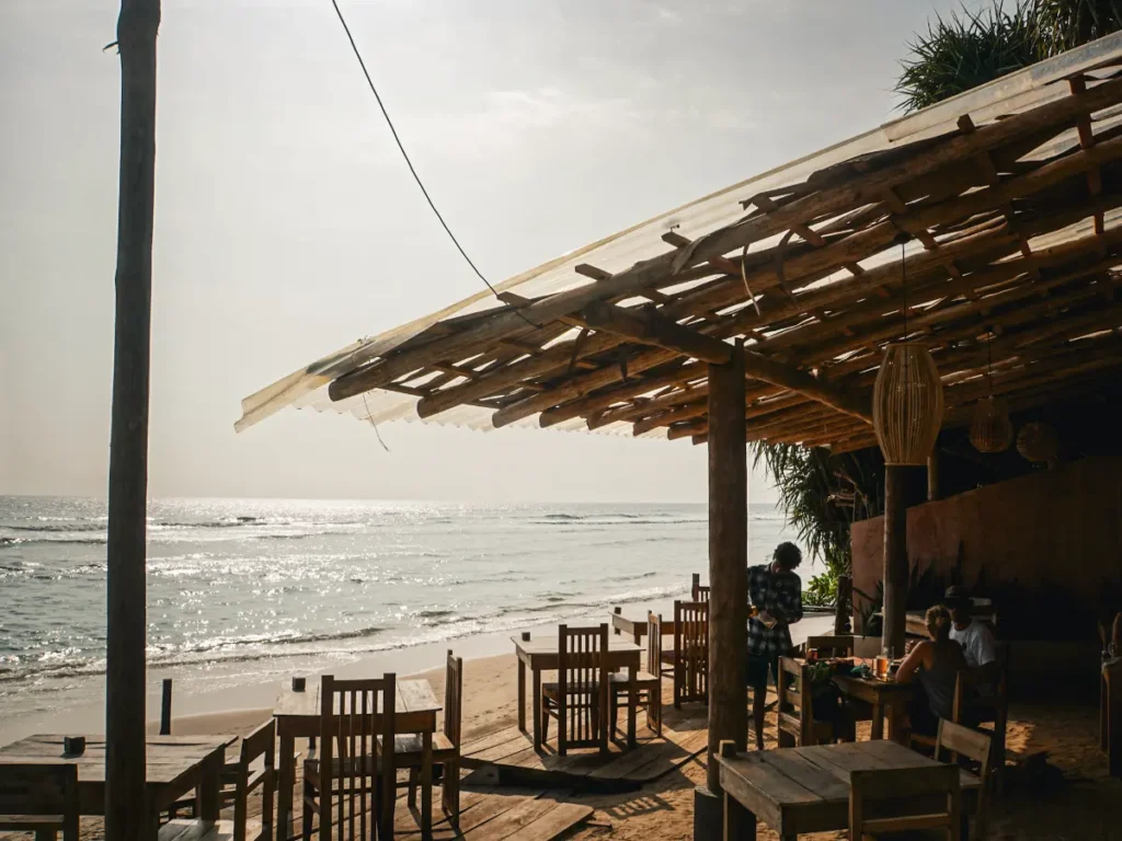 The wooden decking and two people having food at Thileni's
