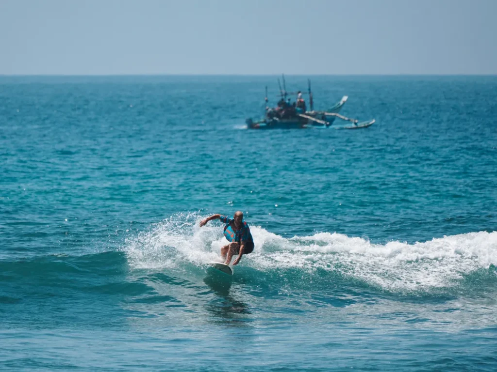 A surfer riding a wave at The Cove / Gas Stations in Ahangama