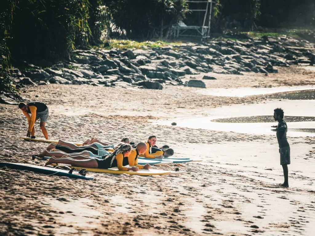 An instructor taking a surf camp for a lesson in Ahangama