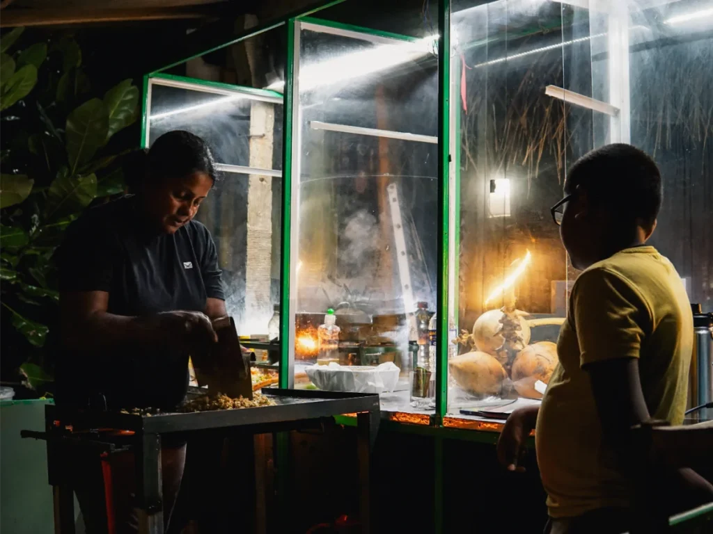 A mother and son cook local food in Madiha