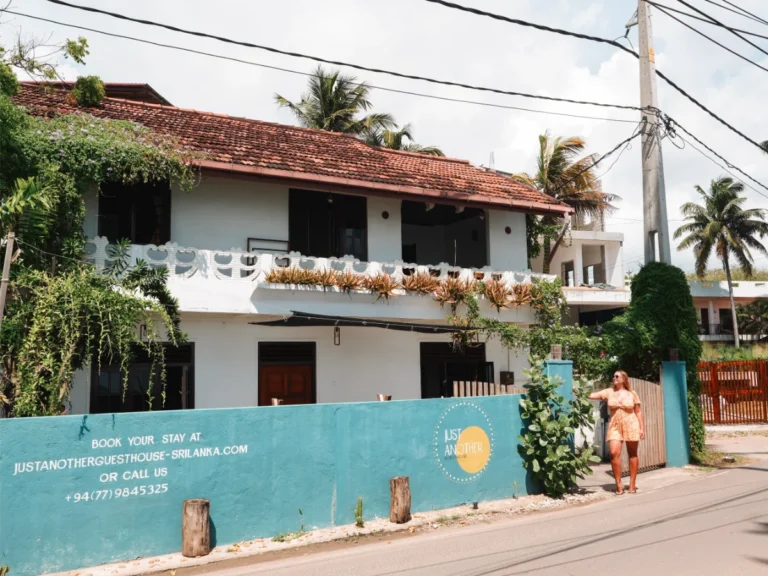 A girl stands out front of Just Another Guesthouse, a great option to stay Madiha