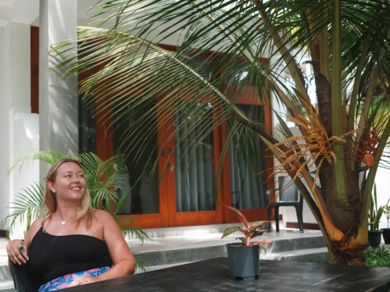 A girl sits in the garden of New Ocean Breeze Villa