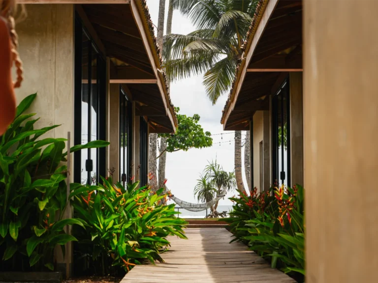 Views down the walkways of the ocean, the hammack and the bungalows at Swell Shacks