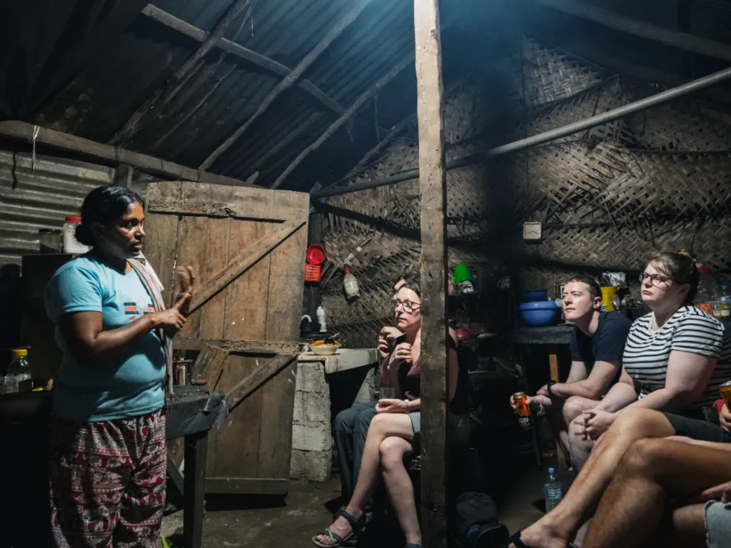 A local women teaching travellers about spices at a cooking class in Sigiriya