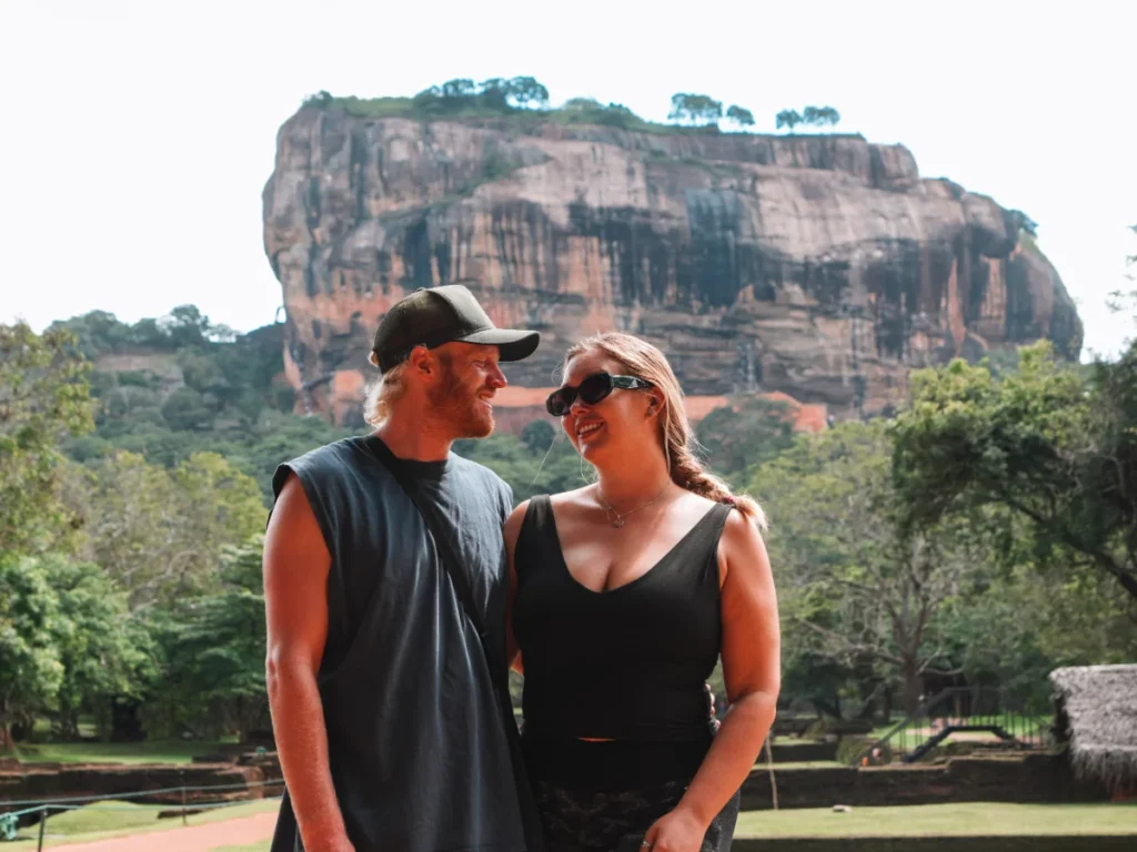 A couple smiling as the explore the Lion's Rock fortress