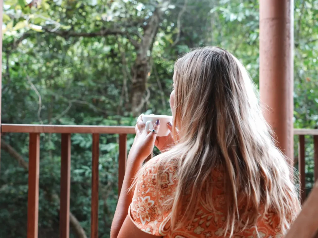 A girl drinking a cup of tea in her hotel in Sigiriya